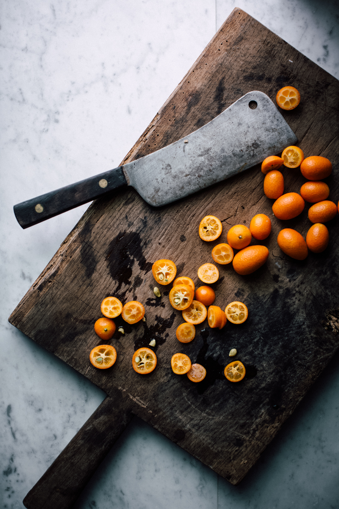 Kumquats on cutting board.
